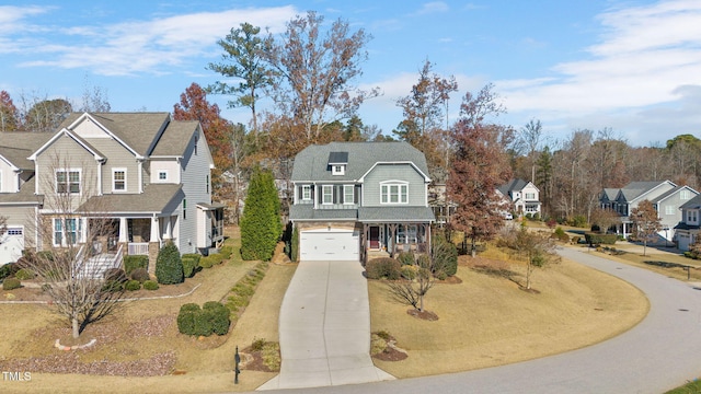 view of property with covered porch and a garage