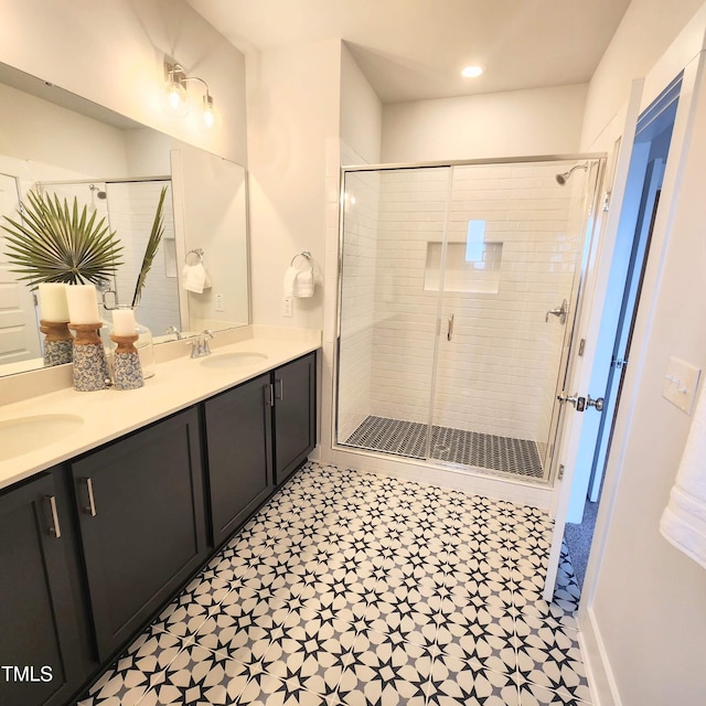 bathroom with a shower with door and vanity