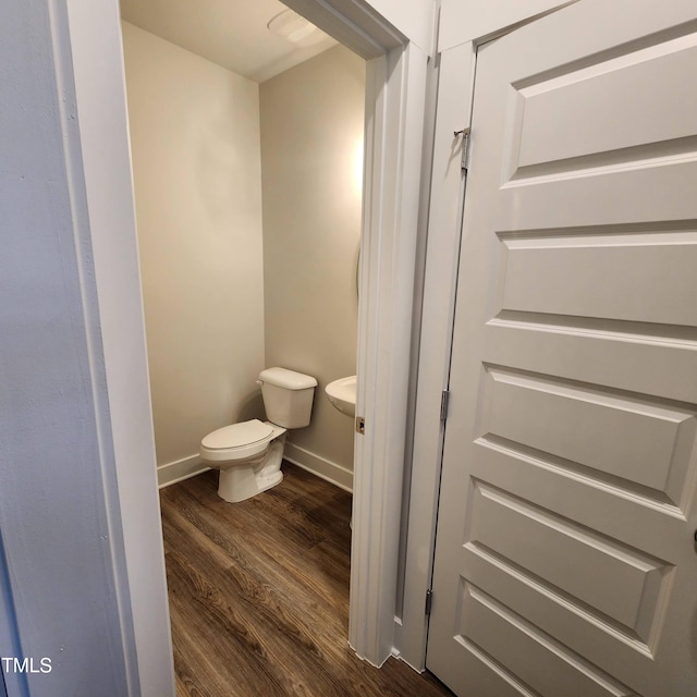 bathroom featuring wood-type flooring and toilet