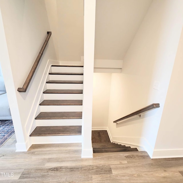 stairs with hardwood / wood-style floors