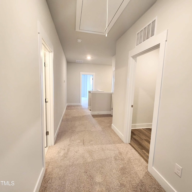 hallway featuring light carpet