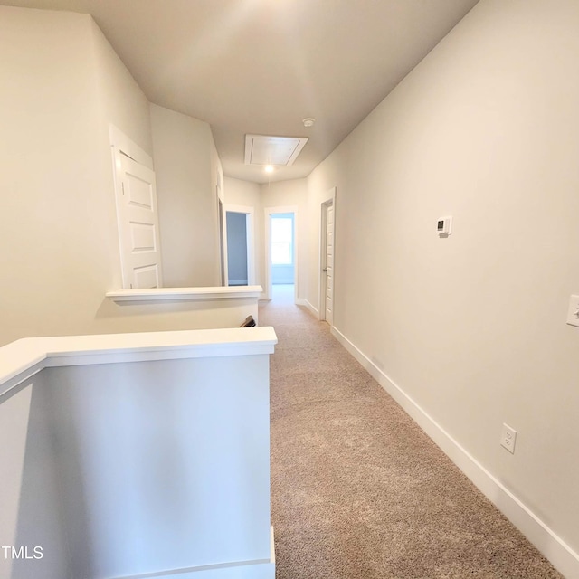 hall featuring light colored carpet