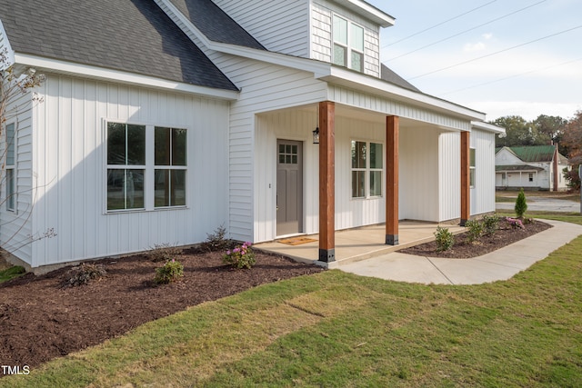 property entrance with a yard and a porch