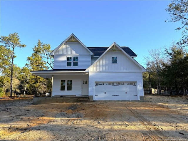 view of front of property featuring a garage and covered porch