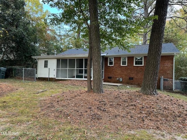 back of house featuring a sunroom