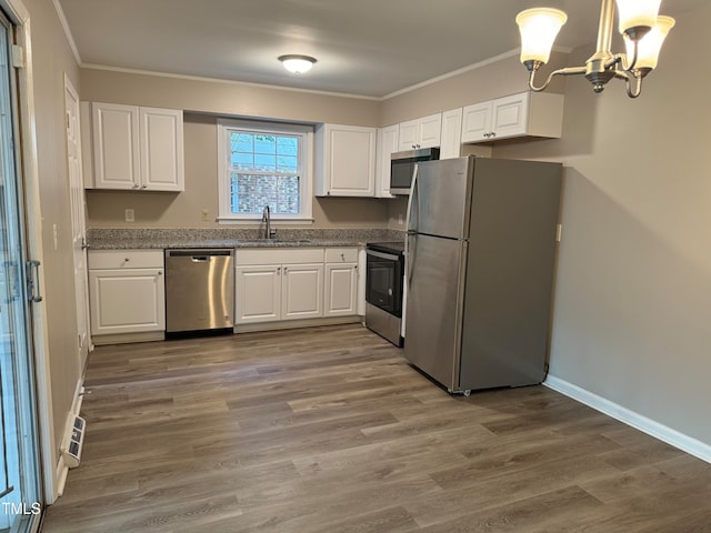 kitchen featuring white cabinetry, stainless steel appliances, wood-type flooring, and sink