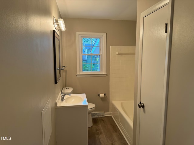 bathroom with wood-type flooring, toilet, and vanity