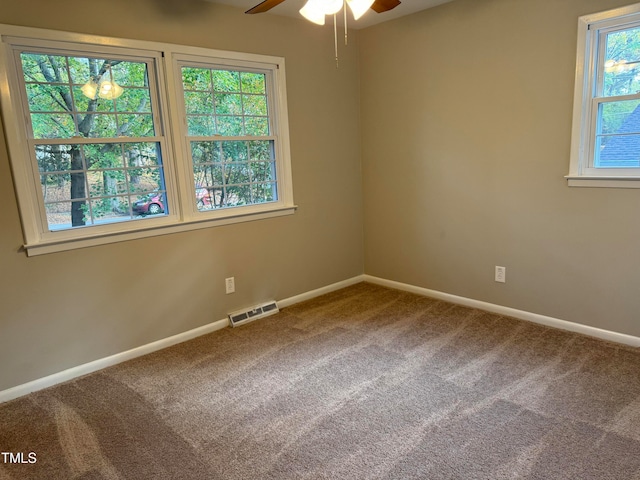 empty room featuring ceiling fan and carpet flooring