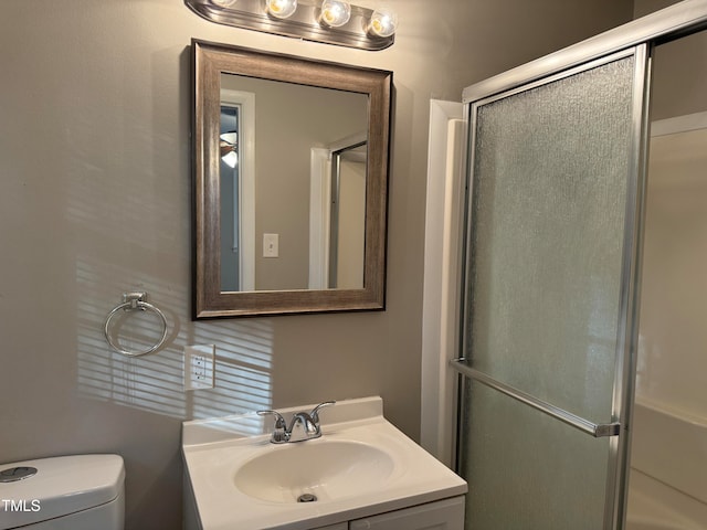 bathroom featuring walk in shower, vanity, and toilet