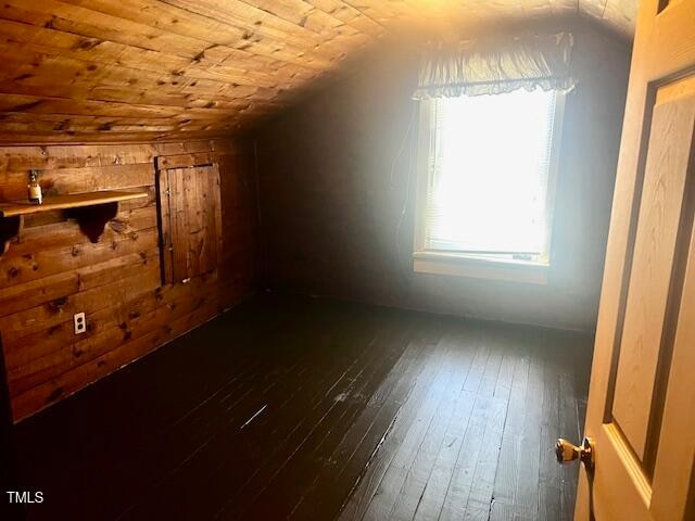 bonus room with dark wood-type flooring, wooden ceiling, and lofted ceiling