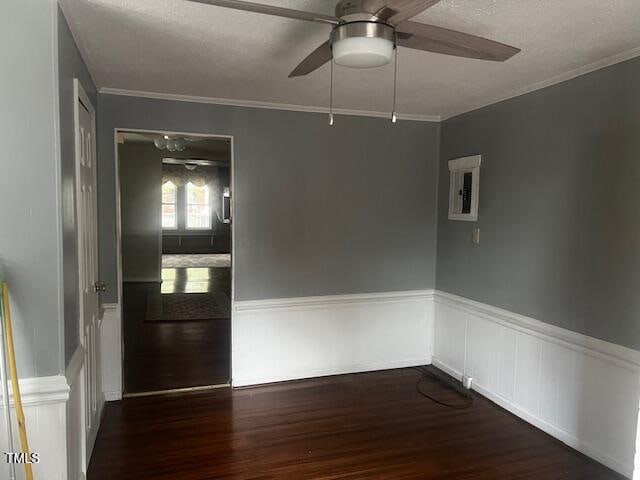 spare room with dark hardwood / wood-style floors, crown molding, and ceiling fan