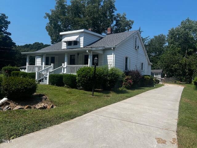 bungalow-style house with a porch and a front yard