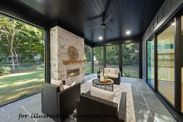 sunroom featuring wood ceiling, a fireplace, and ceiling fan