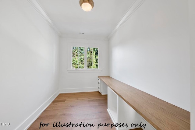 unfurnished office with crown molding and light wood-type flooring