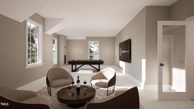 living area featuring light colored carpet and a healthy amount of sunlight