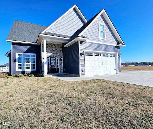 view of front facade featuring a garage and a front lawn