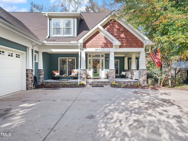 craftsman inspired home featuring a garage and covered porch