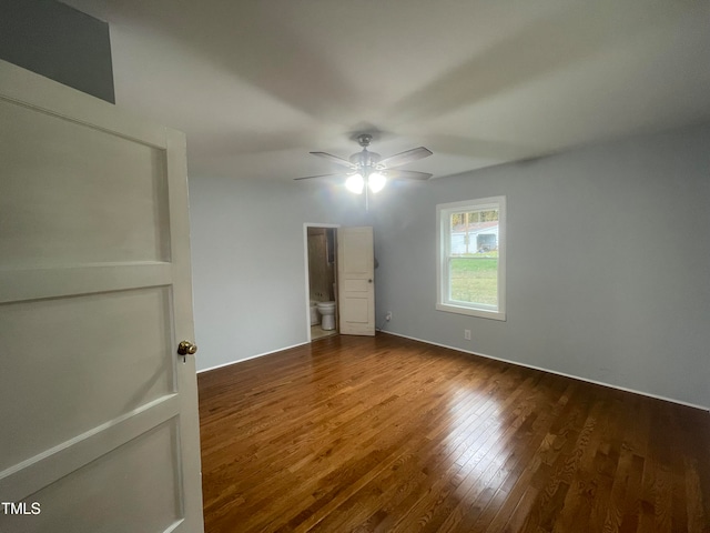 unfurnished bedroom featuring ensuite bathroom, hardwood / wood-style floors, and ceiling fan