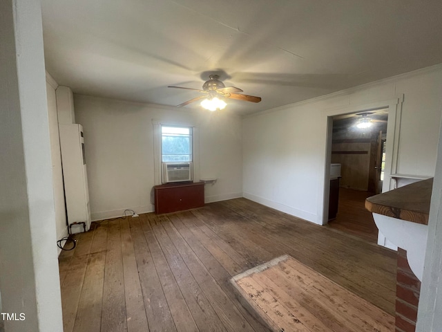 empty room featuring cooling unit, dark wood-type flooring, ceiling fan, and crown molding