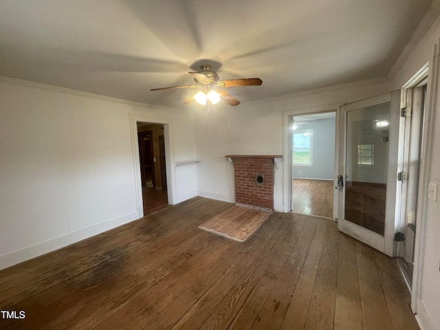 unfurnished living room with ceiling fan, dark hardwood / wood-style floors, a fireplace, and ornamental molding