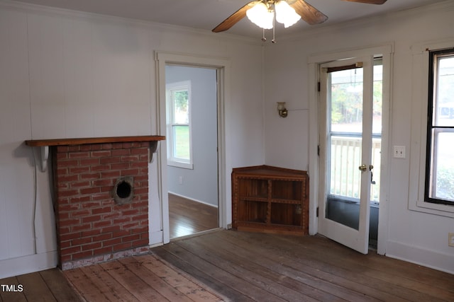 interior space featuring dark wood-type flooring, ceiling fan, a healthy amount of sunlight, and crown molding