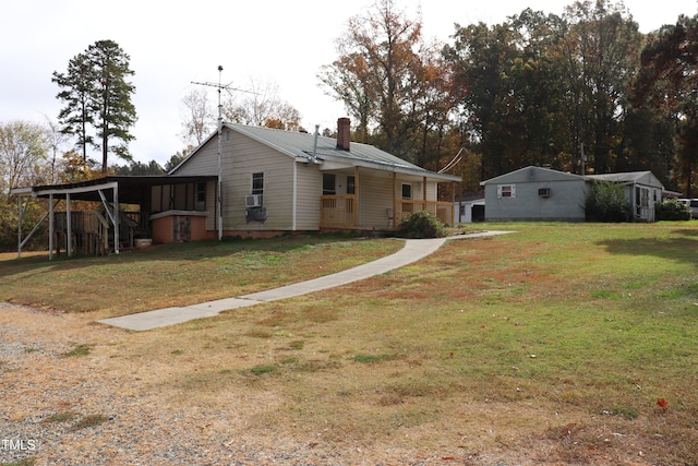 back of property featuring a porch, a yard, and a carport