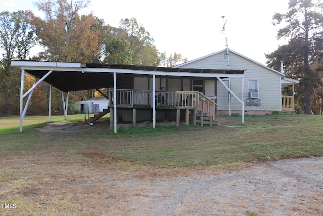 rear view of property featuring a yard and a carport