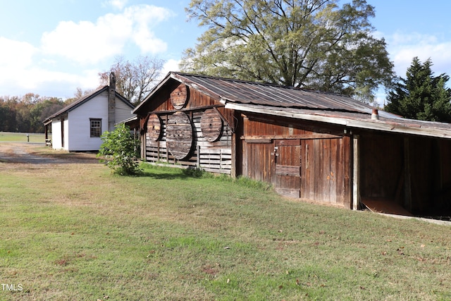 exterior space with an outdoor structure and a yard