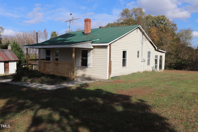 rear view of property with a yard