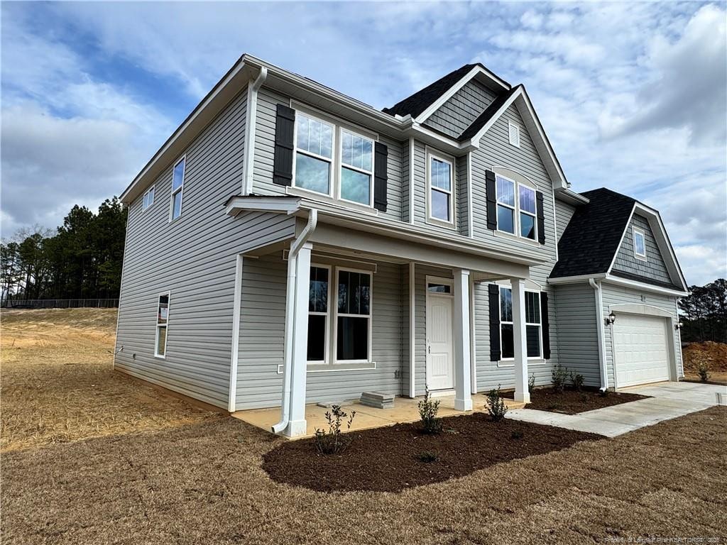 view of front facade with a garage and covered porch