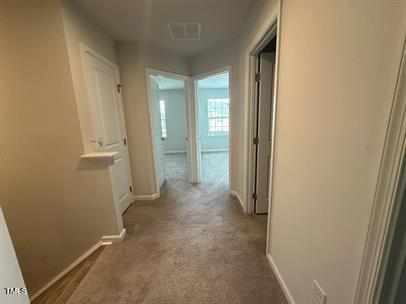 corridor with dark colored carpet