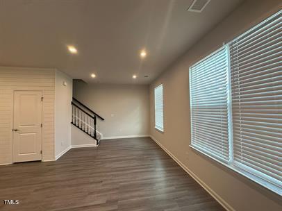 unfurnished living room with dark hardwood / wood-style floors