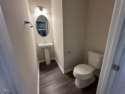 bathroom featuring toilet and hardwood / wood-style floors