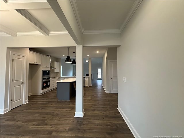 kitchen featuring white cabinetry, decorative light fixtures, a center island, dark hardwood / wood-style flooring, and stainless steel appliances