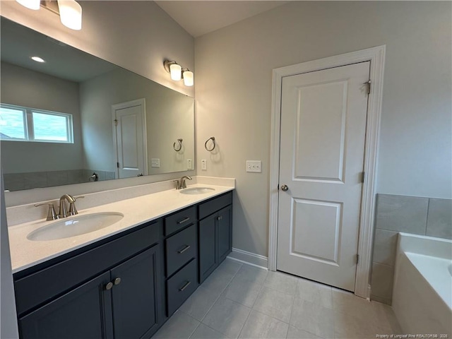 bathroom featuring baseboards, double vanity, a sink, and a tub