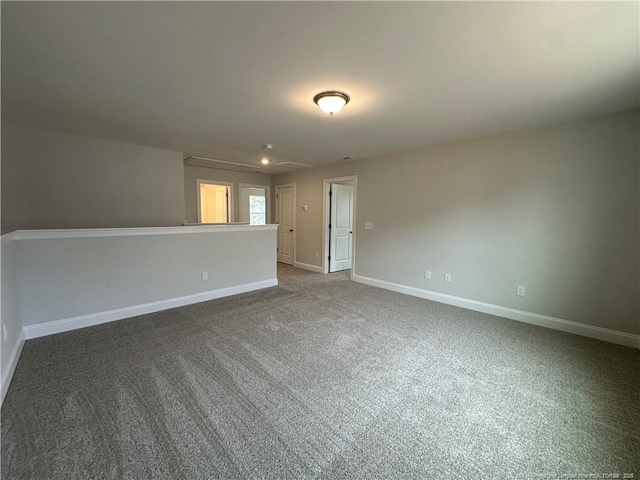 carpeted spare room with baseboards