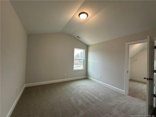 bonus room with lofted ceiling, visible vents, baseboards, and carpet flooring