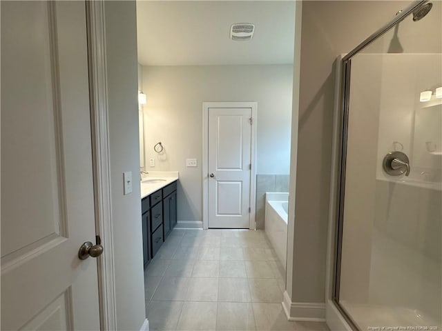 bathroom with visible vents, vanity, a shower stall, a bath, and tile patterned floors