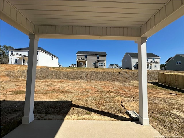 view of yard featuring fence and a residential view