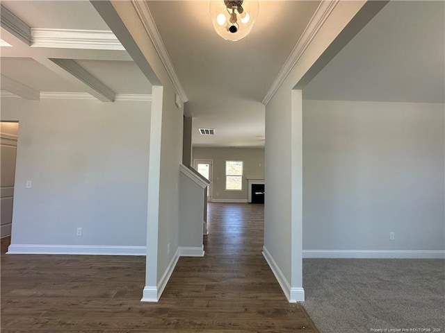 corridor with visible vents, baseboards, dark wood finished floors, and crown molding