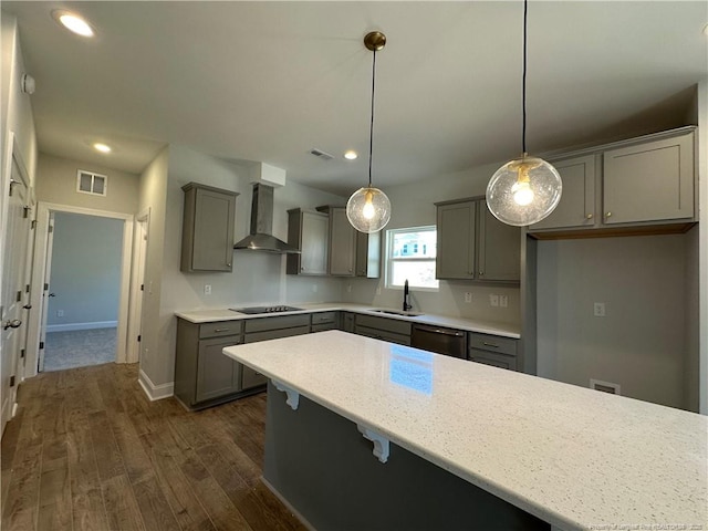 kitchen featuring dishwasher, black electric cooktop, wall chimney range hood, pendant lighting, and a sink