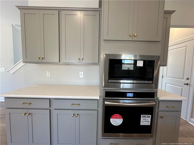 kitchen featuring appliances with stainless steel finishes and gray cabinetry