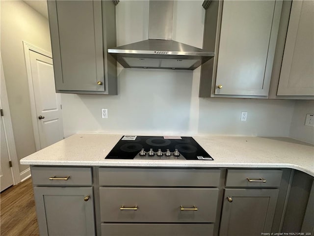 kitchen with gray cabinetry, black electric cooktop, and range hood