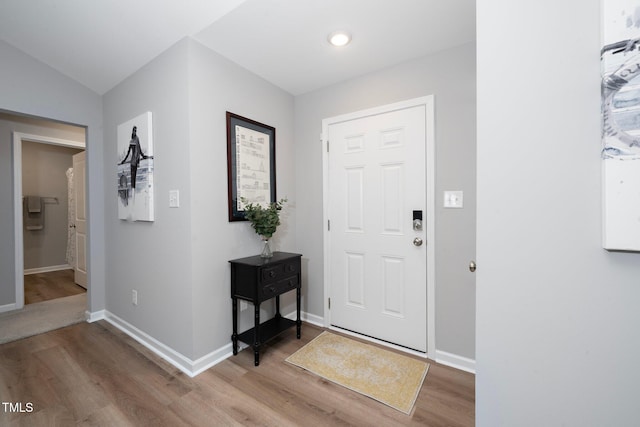 entrance foyer featuring hardwood / wood-style floors and vaulted ceiling