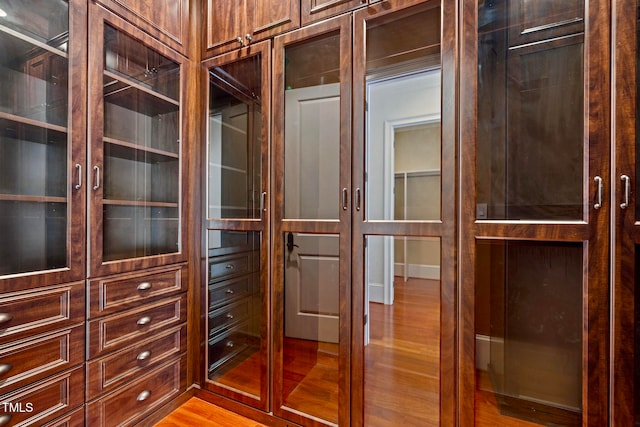 spacious closet with light hardwood / wood-style flooring