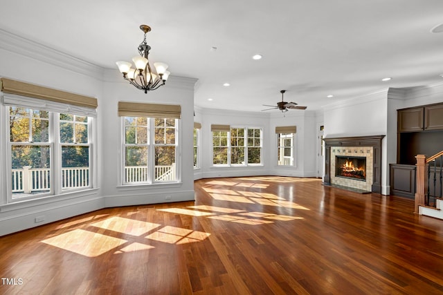 unfurnished living room with a fireplace, light hardwood / wood-style floors, crown molding, and ceiling fan with notable chandelier