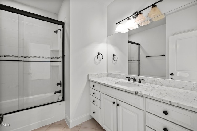 bathroom with combined bath / shower with glass door, vanity, and tile patterned flooring