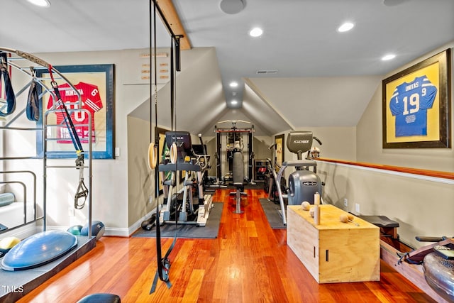 exercise room featuring wood-type flooring and lofted ceiling