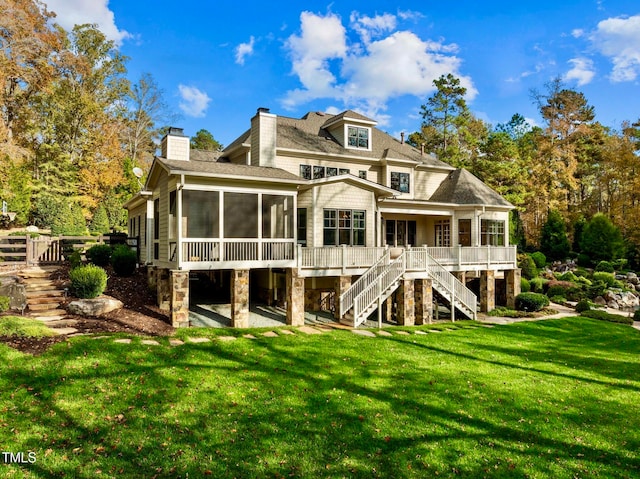 back of property with a sunroom and a yard