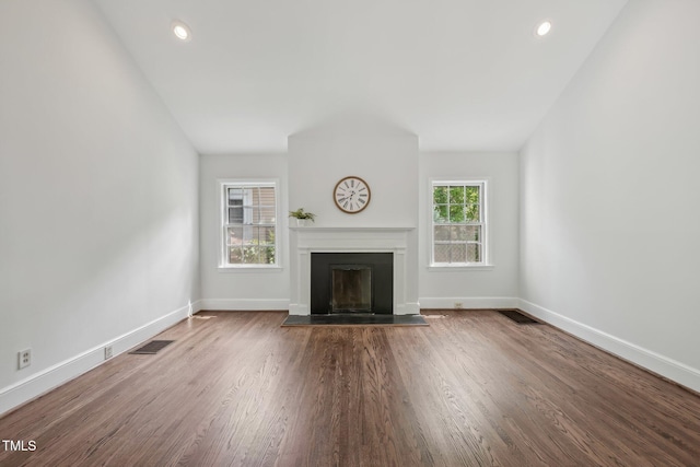 1316 Glenwood Ave, Raleigh, NC 27605 - unfurnished living room featuring visible vents, baseboards, wood finished floors, and a fireplace